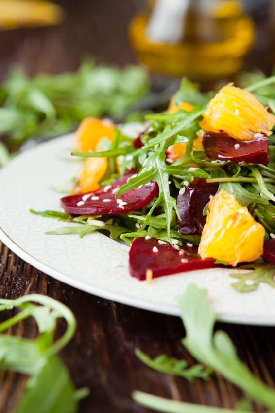 fresh salad with arugula and citrus, healthy food closeup