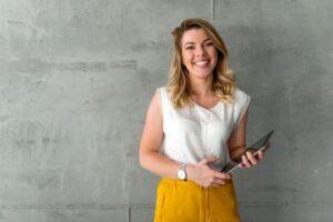 happy health coach with her ipad wondering if she can launch faster with done-for-you programs.