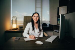 busy coach at her 9 to 5 in her office, wondering if she can launch faster with done-for-you programs.